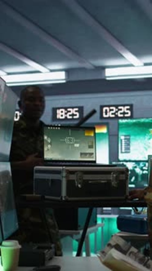 Two Adults in Control Room with Handgun