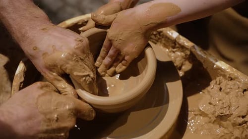 Close Up of Potter Hands Covered with Clay Teaching Girl at Workshop How Making Beautiful Vase on
