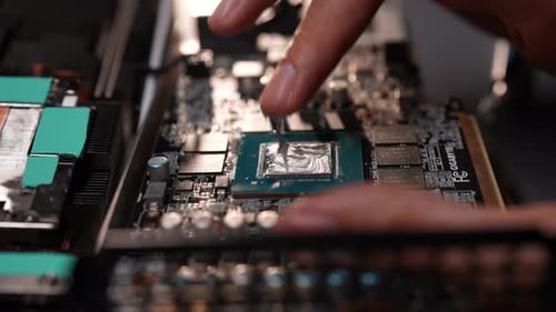 Hands of Unrecognizable Computer Repair Technician Male Applying Thermal Paste to Computer Processor