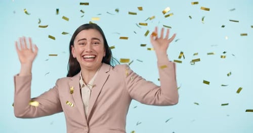 Woman Celebrates as Gold Confetti Falls Around Her