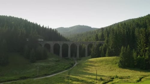 Aerial view of a passenger train crossing Chmarocsky Viaduct in Slovakia.