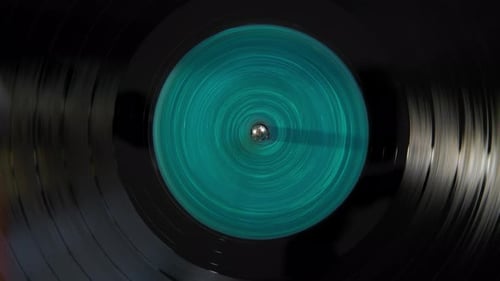 Black Vinyl Retro with Turquoise Color Screen in Center Record on DJ Turntable