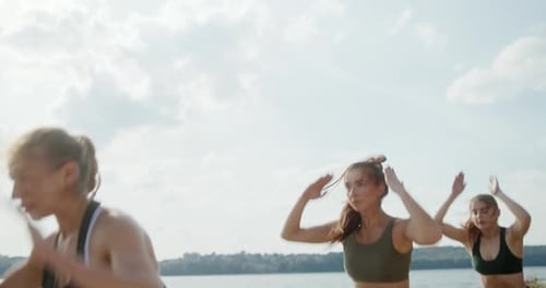 Sportswomen Jumping on Pier Together