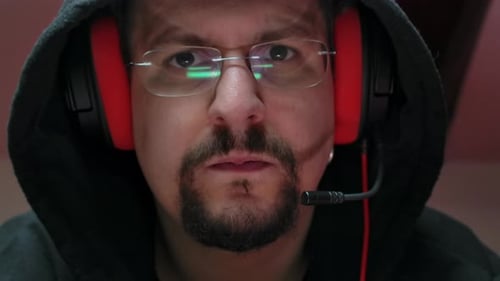 Man Wearing a Headset Staring at Camera