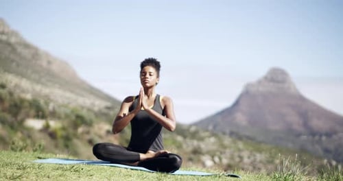 Woman Practicing Yoga in a Mountain Landscape