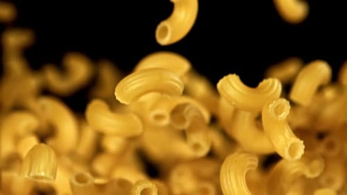 Macaroni Elbow Pasta Floating Deliciously on Black Background