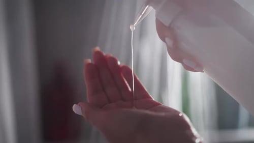 Woman Dispenses Cream Lotion in Shower, Close Up