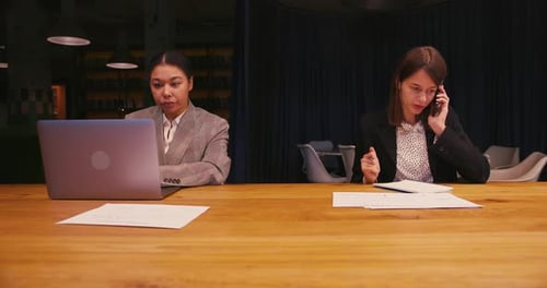Two Women Working Together at Office Table