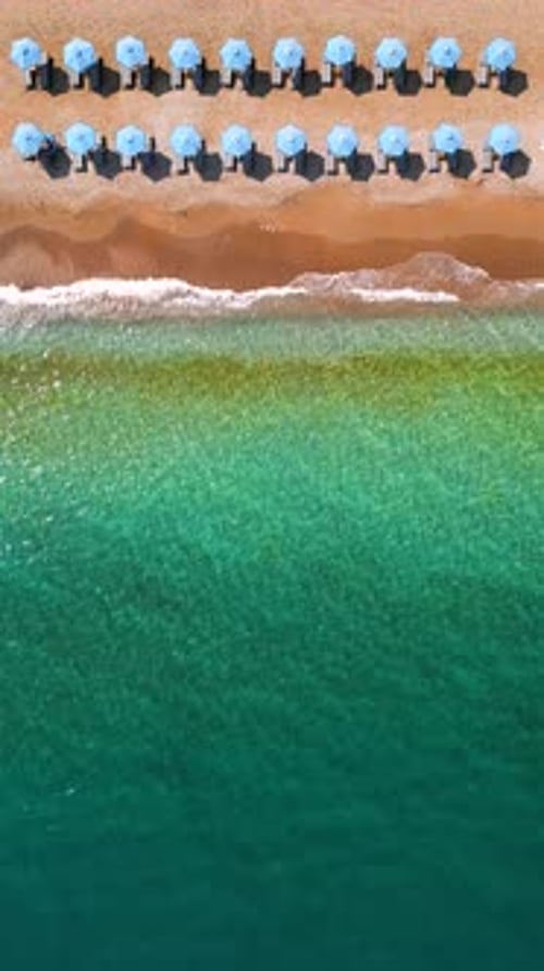Topdown View of Sandy Beach with Sun Umbrellas and Turquoise Sea Water