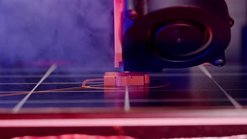 Close-up of 3D Printer Head Manufacturing Orange Object