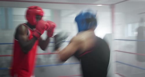 Boxing ring, hit and men in gym with fight, action and champion athlete training for competition