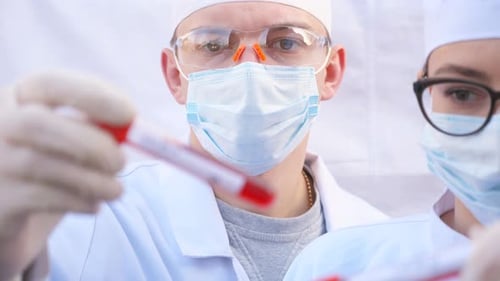 Scientists Examining Blood Samples in Test Tubes