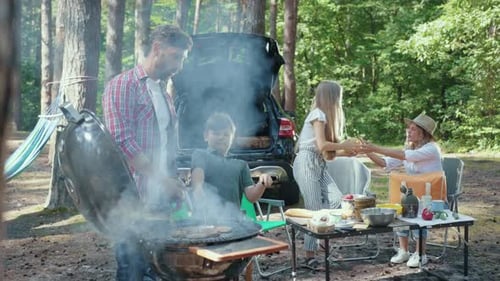 Family Cooking Outdoors at Forest BBQ Grill