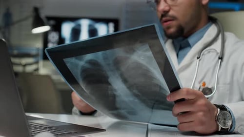 Doctor Reviews X-ray in Office Setting