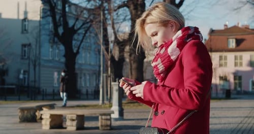 Woman Using Smartphone in Urban City Park