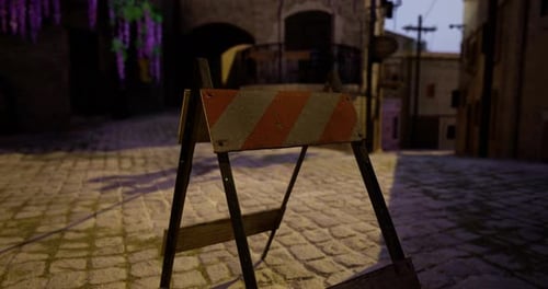 Construction Barrier Blocking Cobblestone Street in an Old Town at Dusk