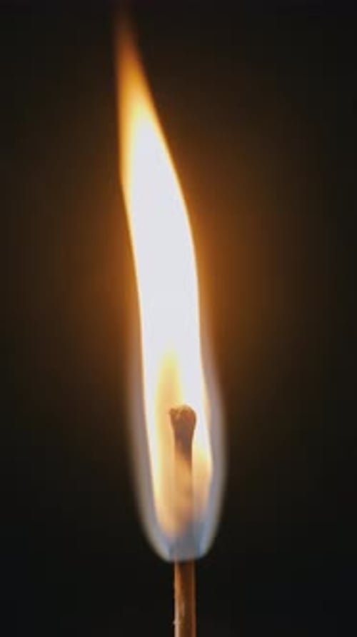 Matchstick Igniting with Bright Flame in Extreme Close Up