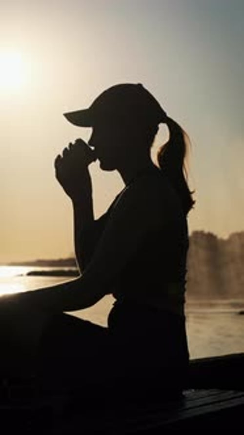 Vertical Young Woman Drinks Warm Coffee at Sunset and Enjoys Life Slow Motion