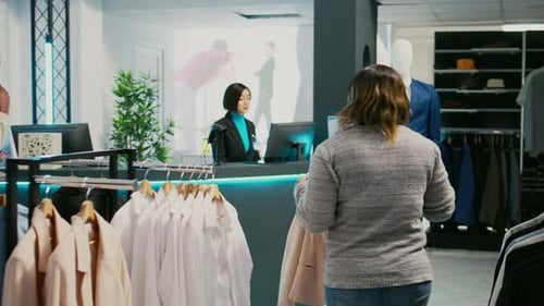 Woman browsing clothing at clothing store