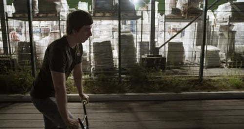 Sportive Man Riding BMX in Evening City