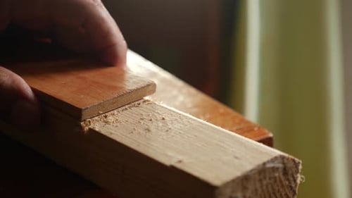 04f. A wooden board is cut with a saw. Carpentry works. A tool for working with wood.