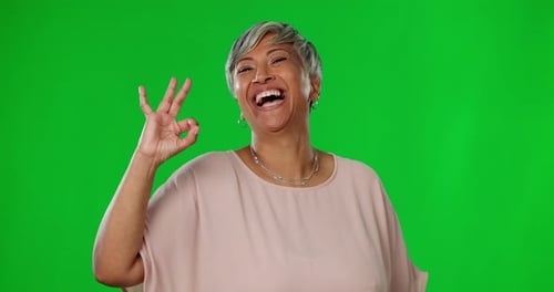 Smile, green screen and okay hand gesture, portrait of woman on studio background with mock up