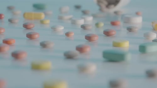 Colorful Medicine Pills Scattered with Bottle