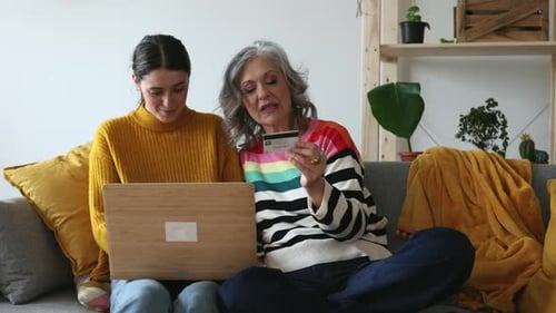 Women Shopping Online on Laptop with Credit Card