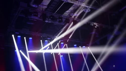 Lighting Equipment Suspended From the Ceiling of a Large Stadium Static Picture White Blue Red