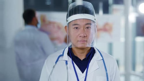Doctor with face shield in a hospital environment