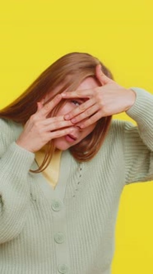 Mulher madura curiosa fechando os olhos com as mãos e espionando os dedos, se escondendo e espiando