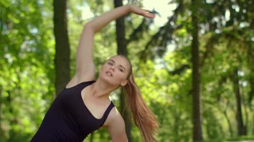 Fitness Woman Stretching Outdoor. Fitness Training in Summer Park. Young Sportswoman Doing