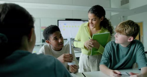 Teacher Explains Wind Turbine to Students in Classroom