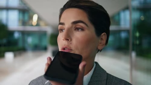 Professional Woman Using Voice Assistant on Phone