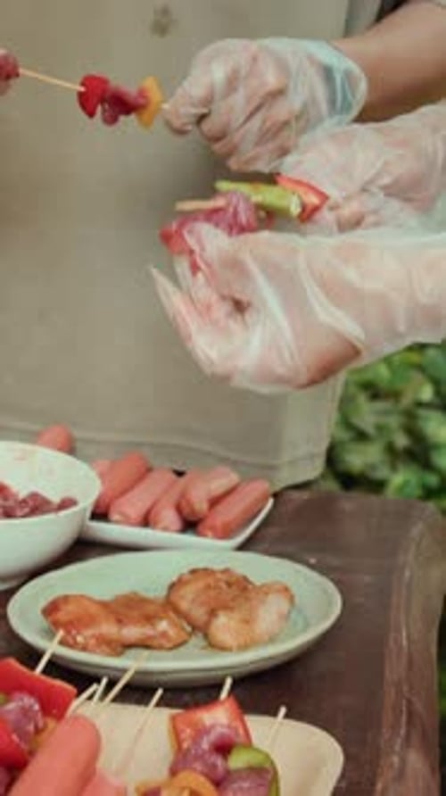 Close Up of Skewers Being Prepared on Table