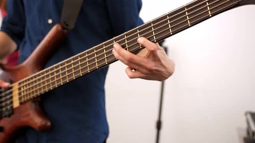 Close Up of Musician Playing Bass Guitar