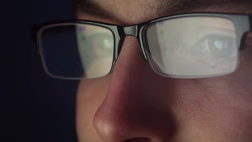 Bar chart reflection in trader glasses, closeup view of man trading stocks or cryptocurrency