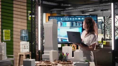 Real Estate Developer Reviewing Architectural Blueprints and Digital 3D Models