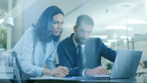 Business Colleagues Discussing Work Together on Laptop