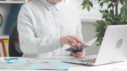 A Travel Agent Typing on a Laptop Keyboard