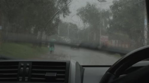 Driving in the rain in African through city