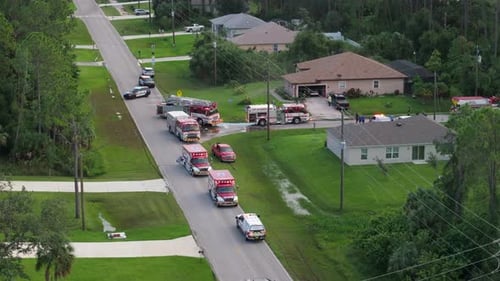 Aerial view of emergency vehicles at suburban house