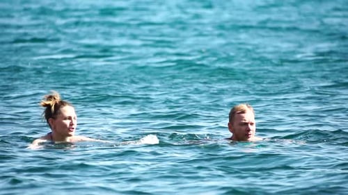 Couple Swimming in the Azure Ocean