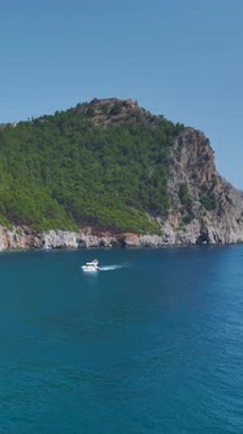 Vertical Video White Yachts With Tourists Sailing Along the Coastline With Stunning Sea and Sky