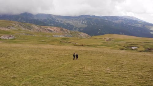 Happy couple hiking through the Carpathian Mountains, Transylvania, Romania