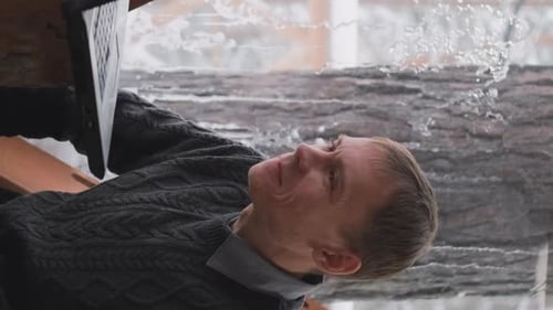 Man Using Laptop for Video Call in Winter