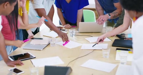 Adults Collaborating Around Conference Table with Technology