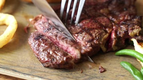 Slicing a Delicious, Well-Done Steak on Platter