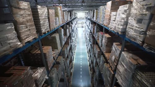 Aerial view of organized palettes and materials inside large warehouse logistics terminal