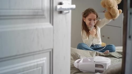 Child Using Nebulizer on Bed with Toy Dog
